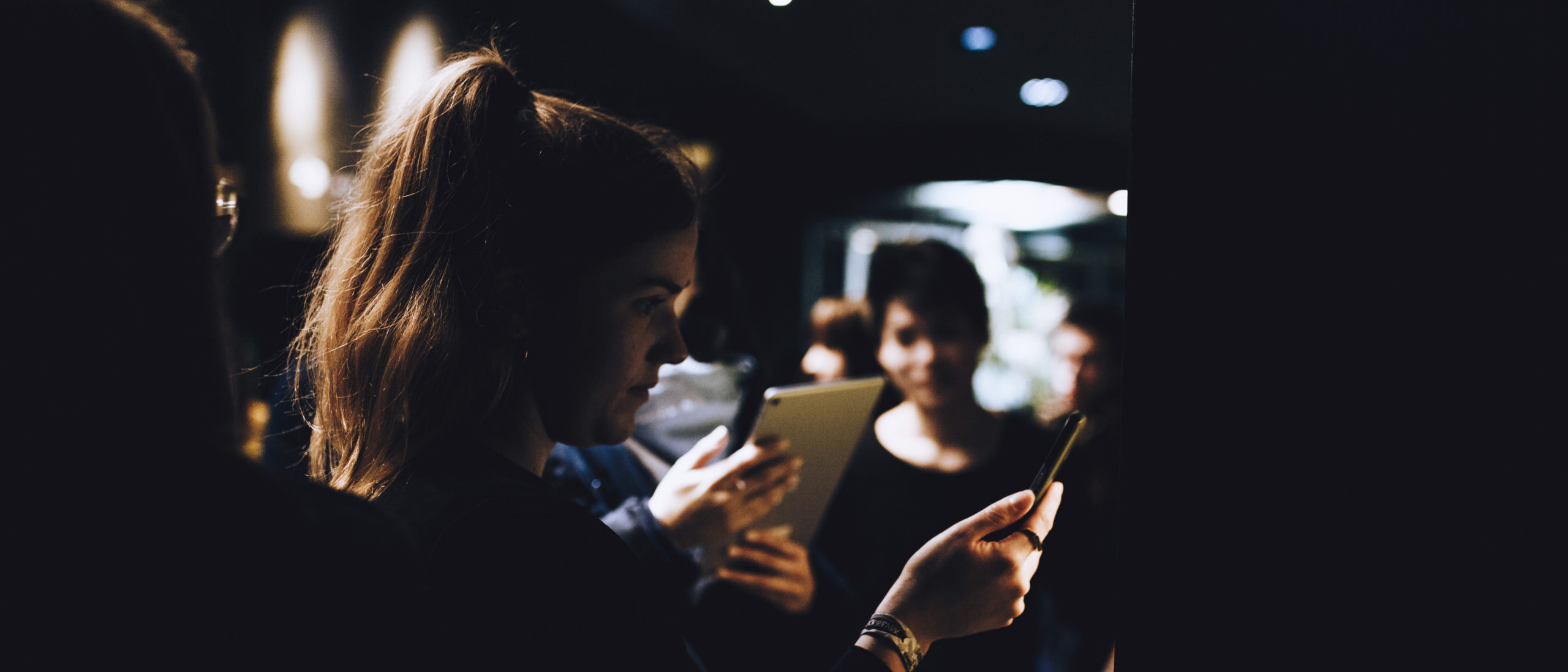 Visitors in the exhibit using tablets for the AR experience